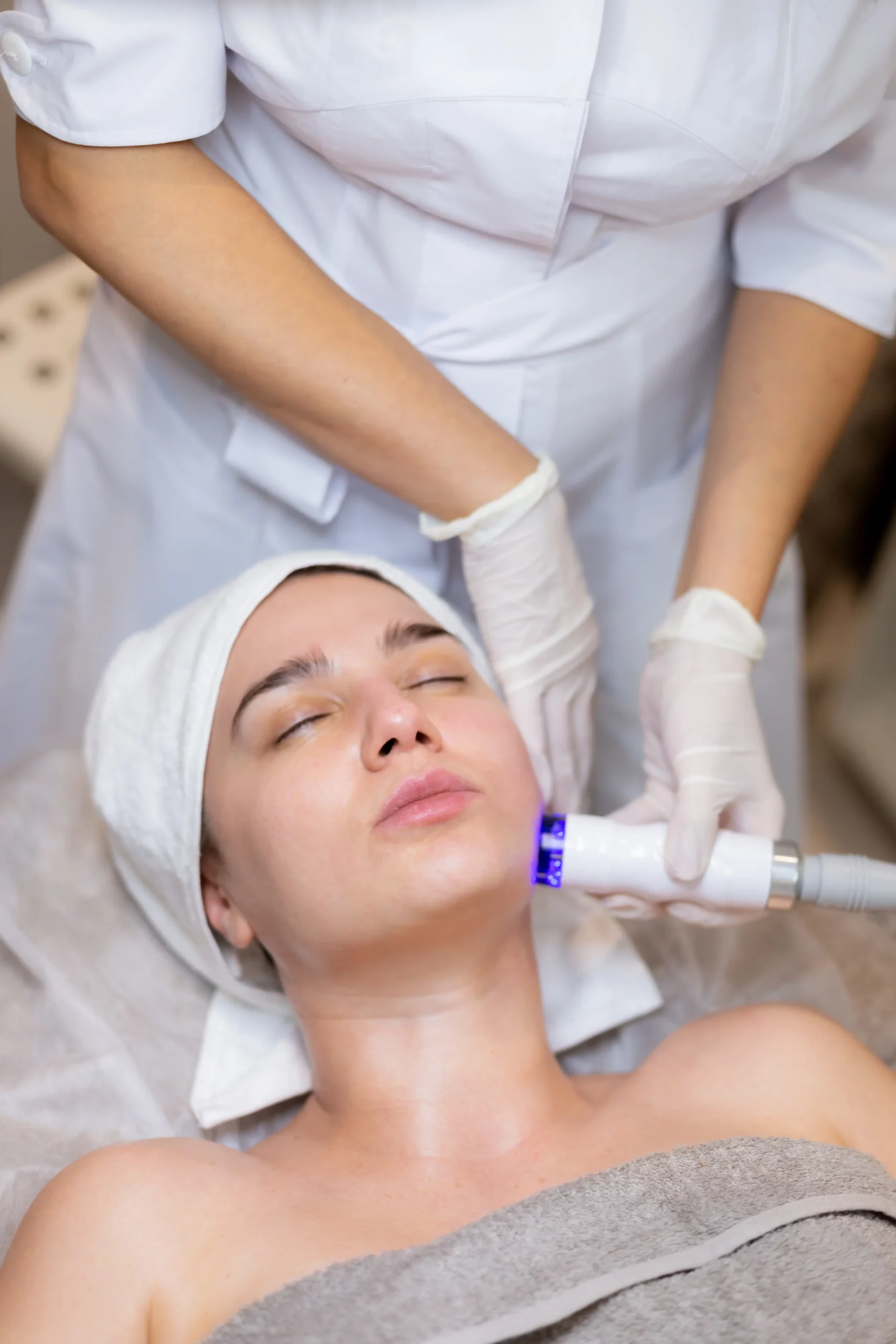 Woman receiving professional laser facial treatment at Park City Medesthetix medical spa for skin rejuvenation